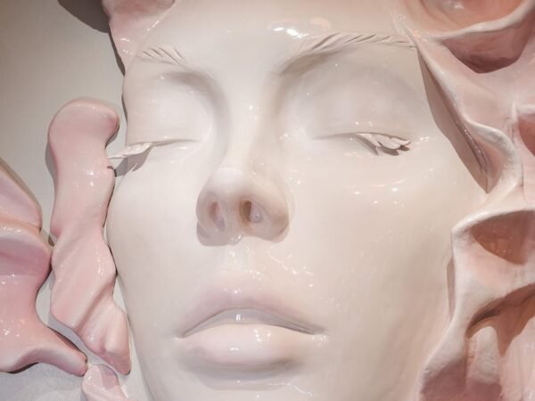 Sculpted face wall at Q Centre